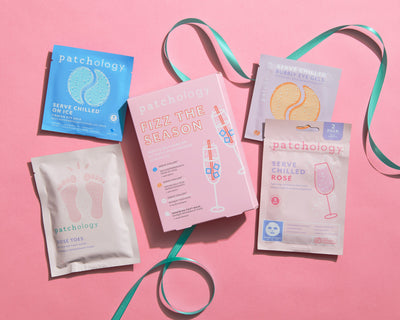 4 products and the packaging laying on a pink background