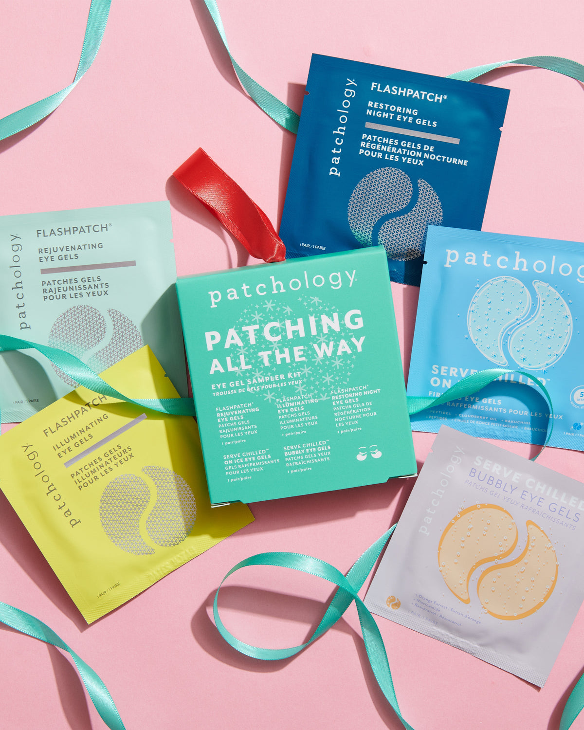 5 products and the packaging laying on a pink background